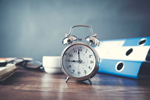 Clock with stationery on table