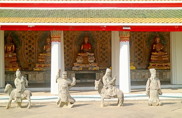 Cloister of Wat Arun Temple with Buddha Images and Chinese Guardian Sculptures in Bangkok Thailand