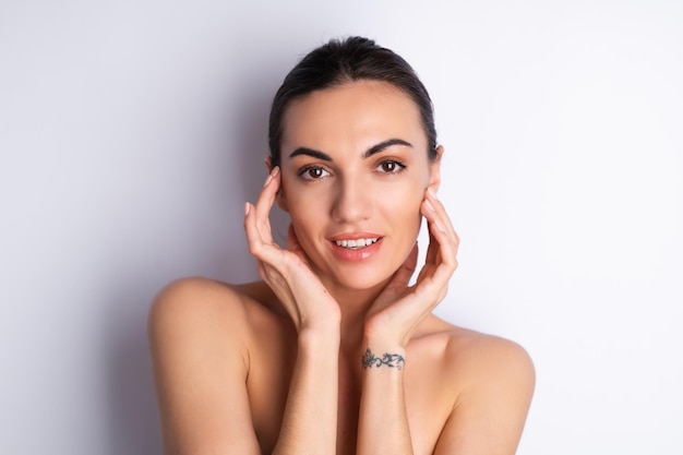 Close beauty portrait of a topless woman with perfect skin and natural makeup plump nude lips on a white backgroundx9