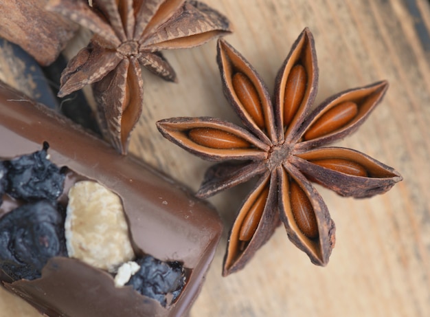 Close on star anise with chocolat on brown wooden table 