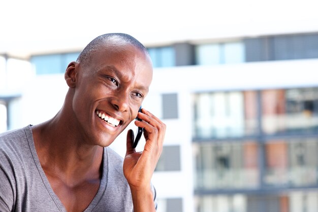 Close up african american laughing with cell phone