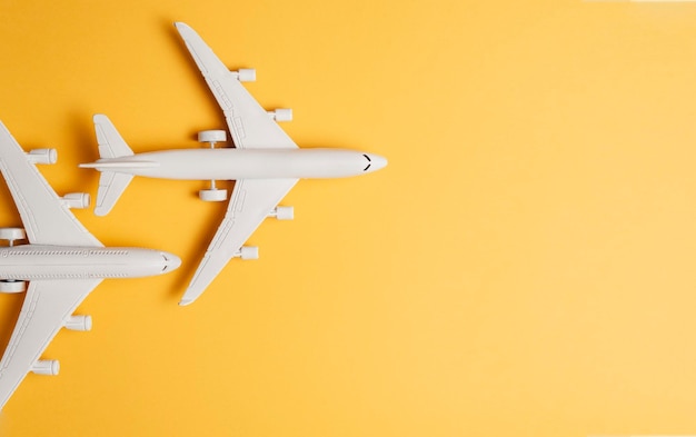 Close-up of airplane over yellow background