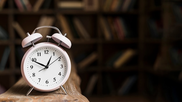 Close-up of a alarm clock on wooden desk