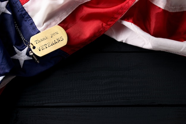 Close up american flag with tag thank you veterans engraved