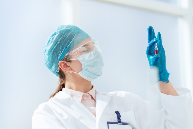 Close up. ampoule with a vaccine in the hands of a female scientist. science and health.