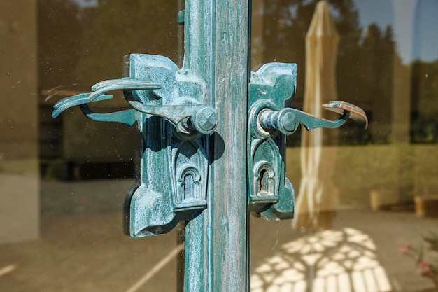 a close up of antique handles of an orangery glass door