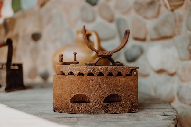 Close up of an antique and rusty iron on wood table background houseworks