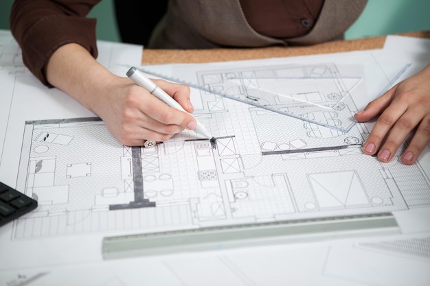 Close up of architect hands working on blueprints. Working on new projects. Architecture and design