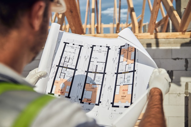 Close up of architect that looking at drawing