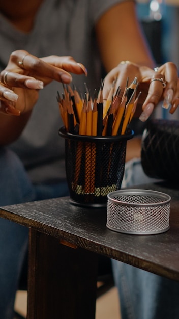 Close up of art tools and pencils on table in artwork space