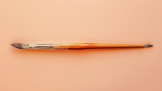 Photo a close up of an artists paintbrush on a peach background