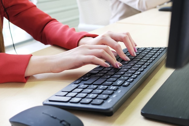 Close up on asian businesswomen hands typing Keyboard on computer desk in office