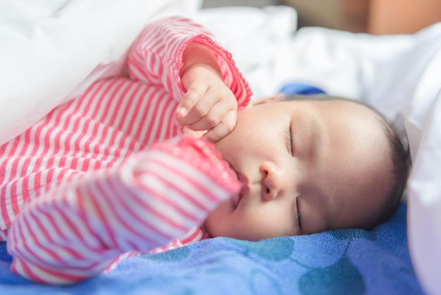 Close up asian cute baby sleep on the bed