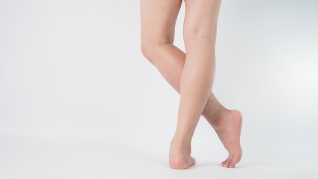 Close up of asian male barefoot and leg on white background