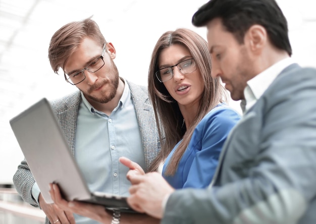 Close up attentive business colleagues looking at the laptop screen