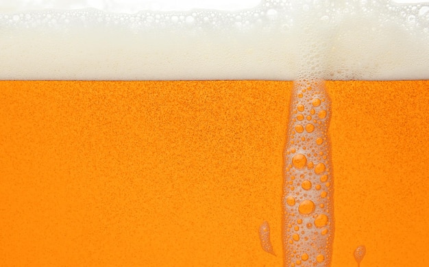 Close up background of beer with bubbles in glass