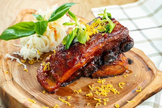 Close up on Baked pork ribs in honey sauce and sauerkraut. Beer snack. Close up. Selective focus