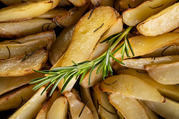 Close-up of baked potatoes with rosemary branch.