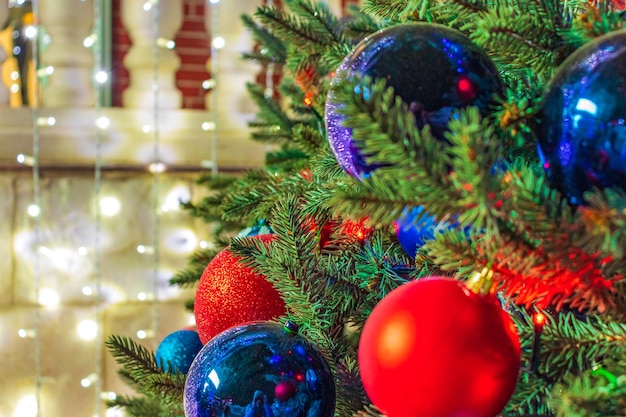 Close up of balls on christmas tree Bokeh garlands in the background New Year concept