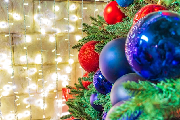 Close up of balls on christmas tree Bokeh garlands in the background New Year concept