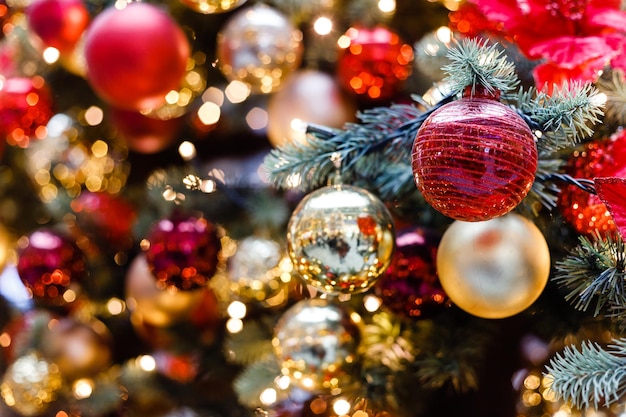 Close up of balls on christmas tree Bokeh garlands in the background New Year concept