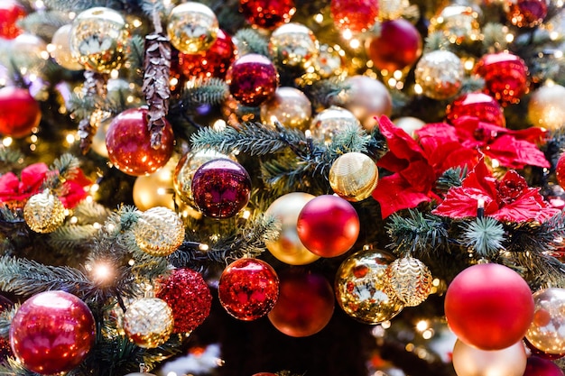 Close up of balls on christmas tree Bokeh garlands in the background New Year concept