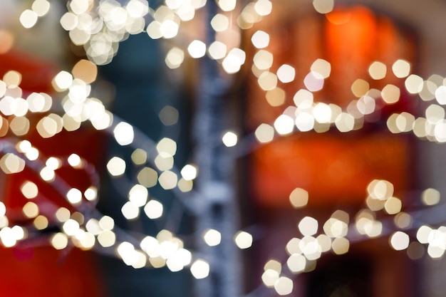 Close up of balls on christmas tree Bokeh garlands in the background New Year concept