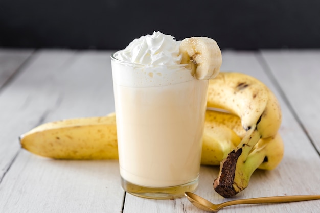 Close-up of banana smoothie with golden spoon