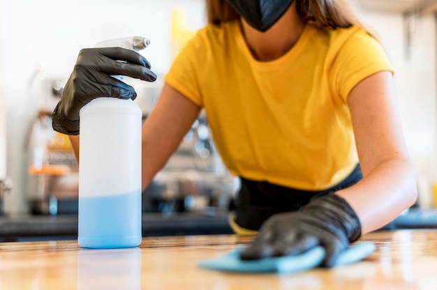 Close-up barista cleaning with desinfectant