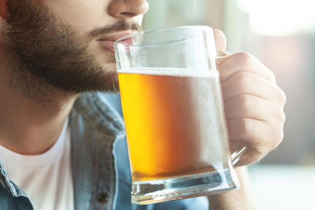 Close up of bearded man drinking beer