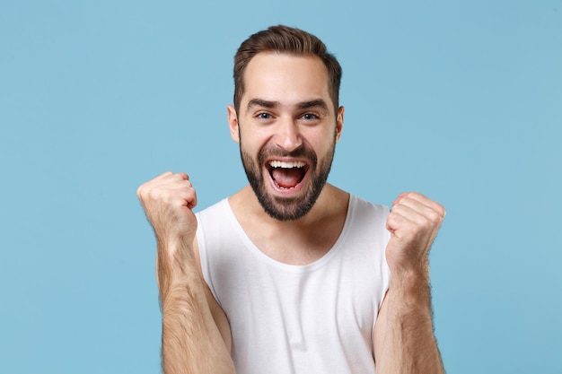 Close up bearded young man 20s years old perfect skin wearing white shirt isolated on blue pastel wall background, studio portrait. Skin care healthcare cosmetic procedures concept. Mock up copy space