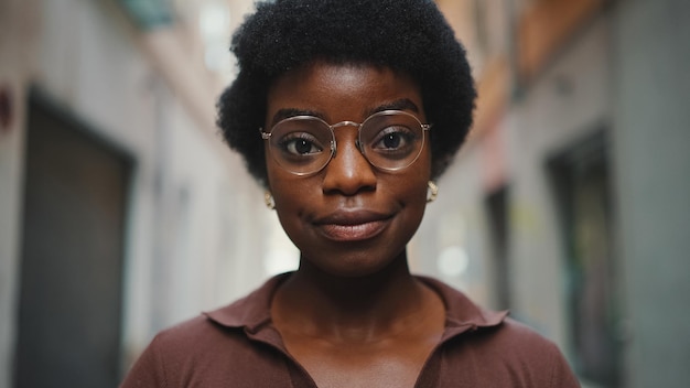 Close up beautiful African girl in glasses looking at camera out