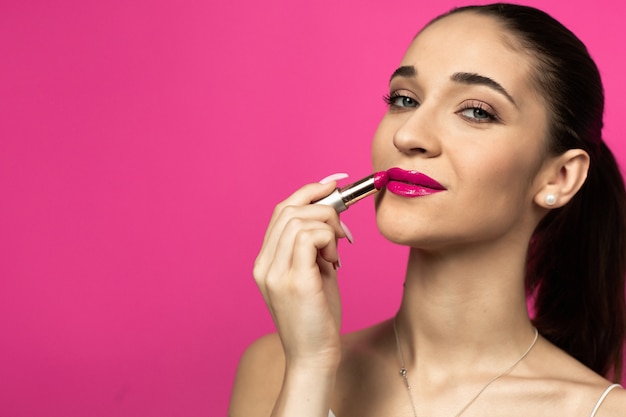 Close up of a beautiful model on a pink background