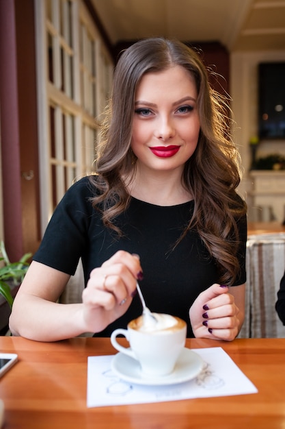 Close up on beautiful woman drinking coffee