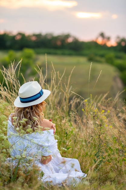 Close up on beautiful woman wearing a dress in nature