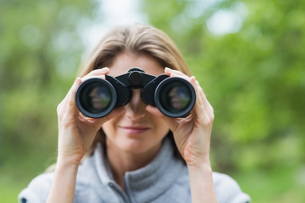 Close-up of beautiful woman with binocular 