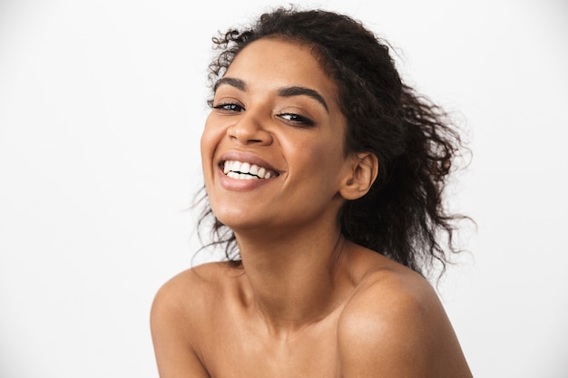 Close up of a beautiful young topless african woman posing over white