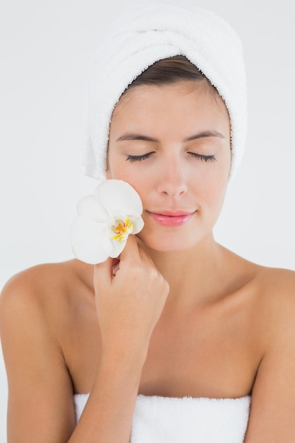 Close up of a beautiful young woman holding flower