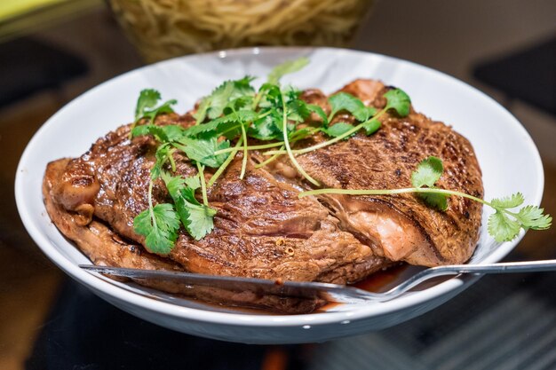 Close-up Beef steak medium rare with parsley on plate