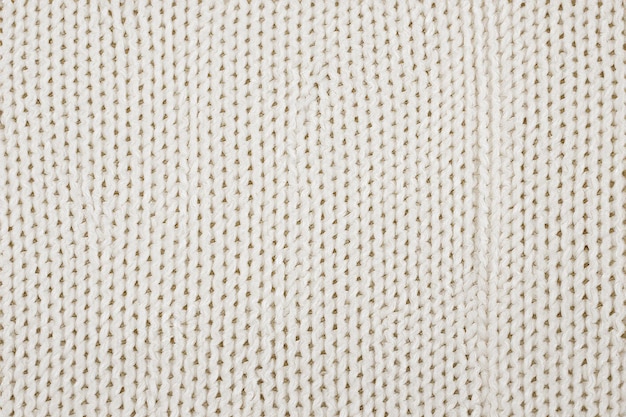 Photo a close up of a beige knitted fabric with a small stitching