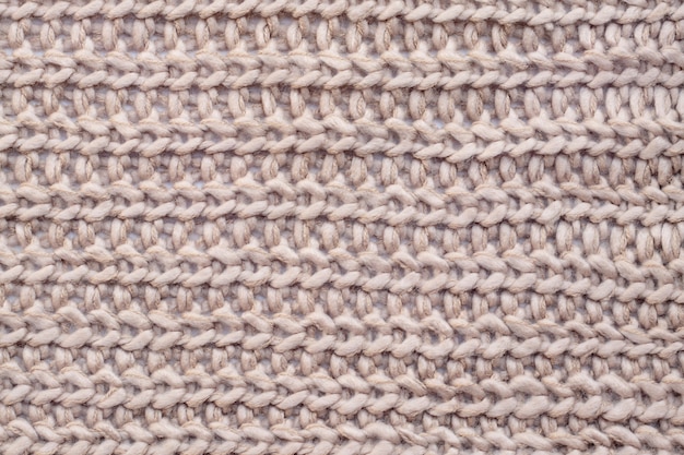 Close up of beige woolen knitted scraf.