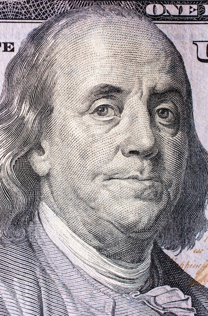 Close up of Benjamin Franklin face on US dollar