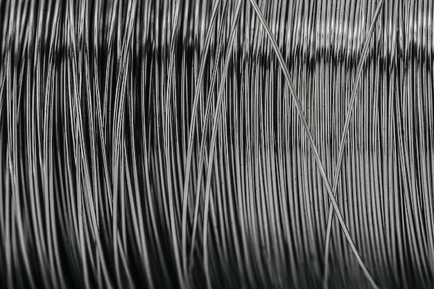 Close up of a big coil of grey shiny steel wires