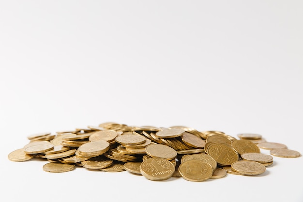 Photo close up of big pile of golden coins isolated on white background. concept of money business growth gain success earnings. copy space for advertisement. with place for text.