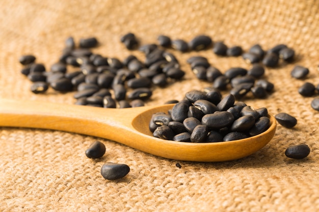 Close up of Black beans with a wooden spoon