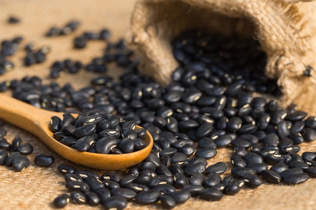 Close up of Black beans with a wooden spoon