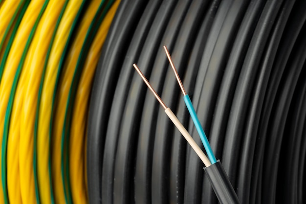 Close up of black electrical wire coil with blue and white wires