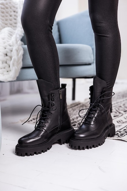 Close up of black womens boots. Fashionable women's stylish leather boots.