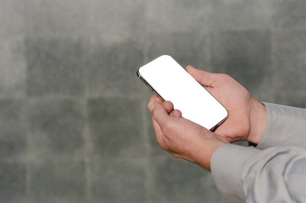 Close up on blank mobile phone held in hand