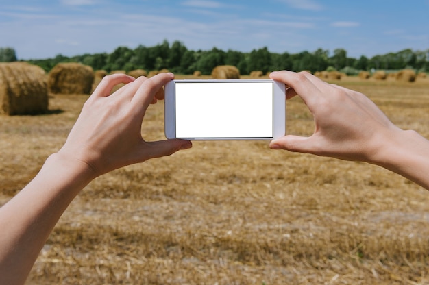 Close up on blank mobile phone held in hand